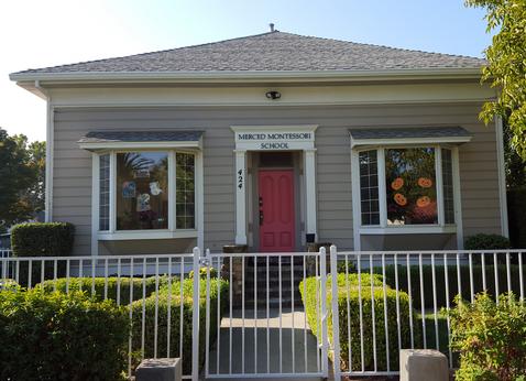 Front of the Merced Montessori School building with a pink door