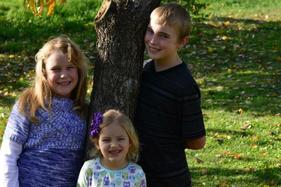 Two children smiling outdoors